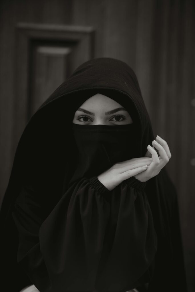 pexels-photo-19298248-19298248 Portrait of a woman wearing a black niqab and abaya, focusing on eyes in a mysterious and elegant pose.